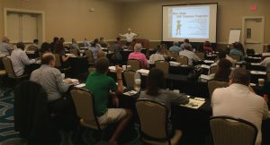 Larry Lawler in front of the room teaching